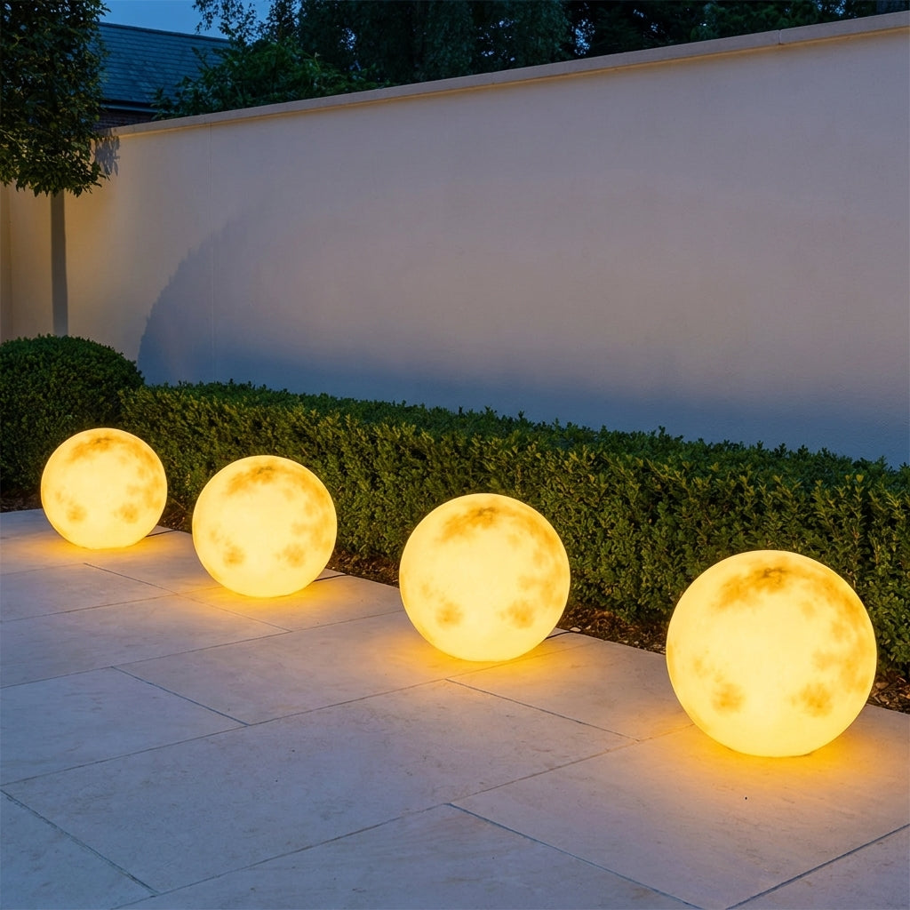 Solar Moon Ball Garden Lights – four glowing moon lights beside a garden hedge