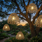 Solar Bell Outdoor Pendant Lantern – lit hanging from a tree at dusk