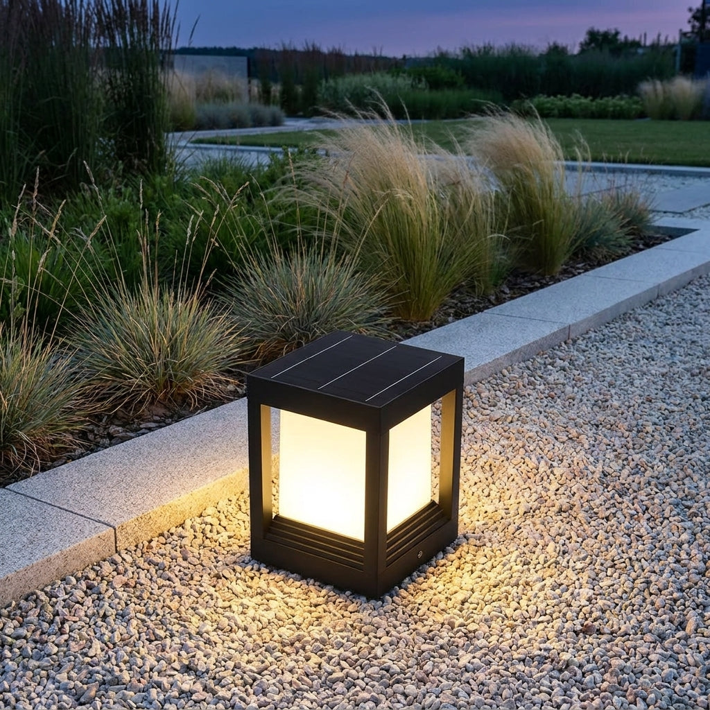 Square Black Solar Fence Post Light – lit on a gravel path at dusk