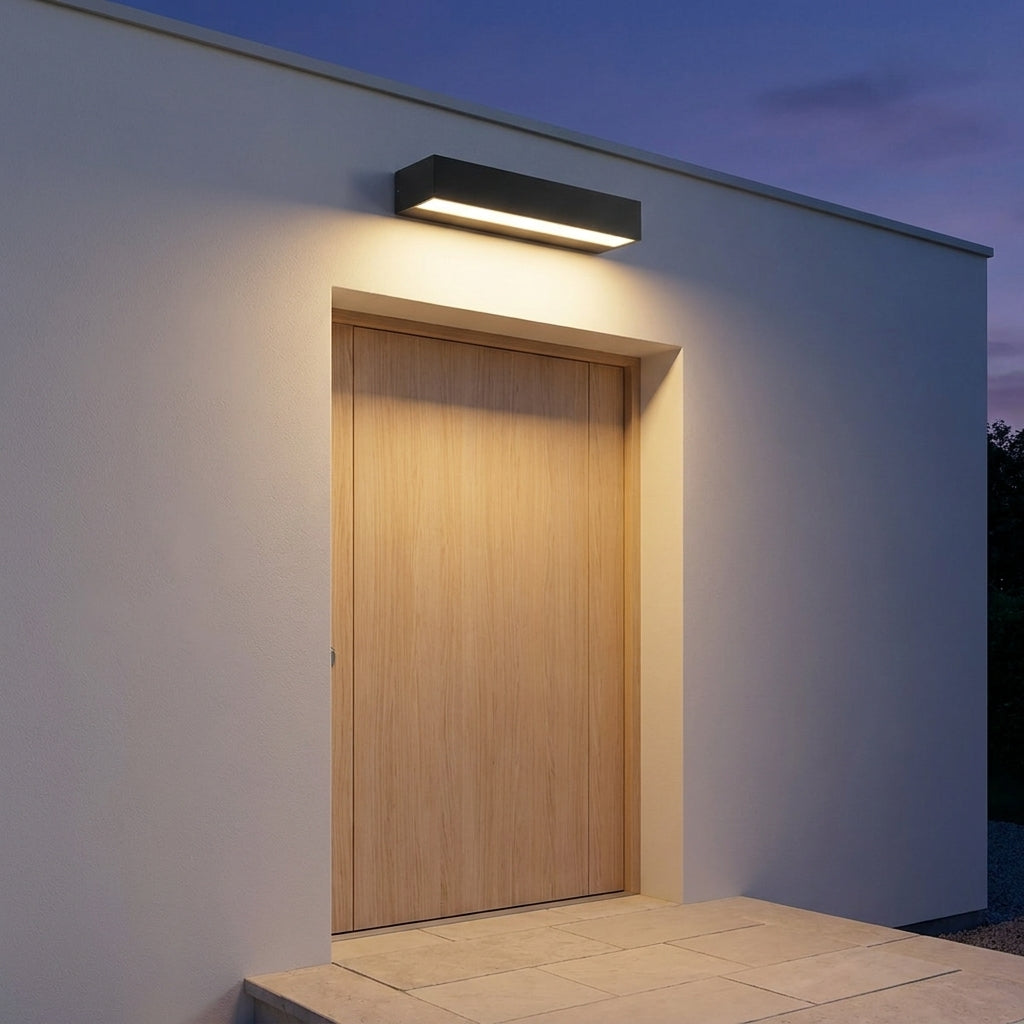 Slim Outdoor LED Wall Washer Light – mounted above a wooden door at dusk