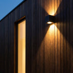 Square Outdoor Up & Down Wall Light – mounted on wood cladding beside a window