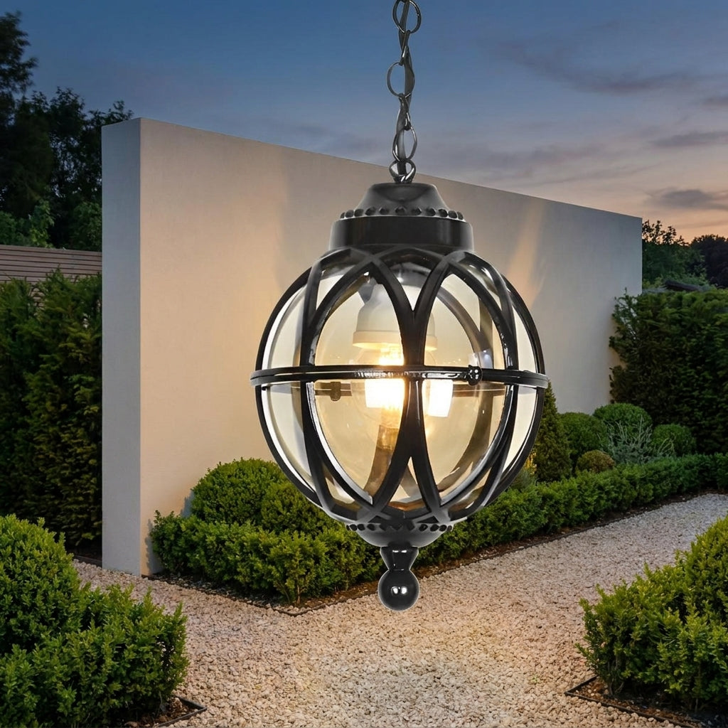 Outdoor Glass Ball Chandelier – hanging on a chain in a garden at dusk