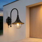 Farmhouse Horn Outdoor Wall Light – lit beside a front door at dusk