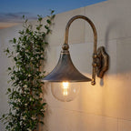 Farmhouse Horn Outdoor Wall Light – on a stone wall beside jasmine at dusk