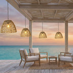 Solar Bell Outdoor Pendant Lantern – lit hanging under a beachside pergola at sunset
