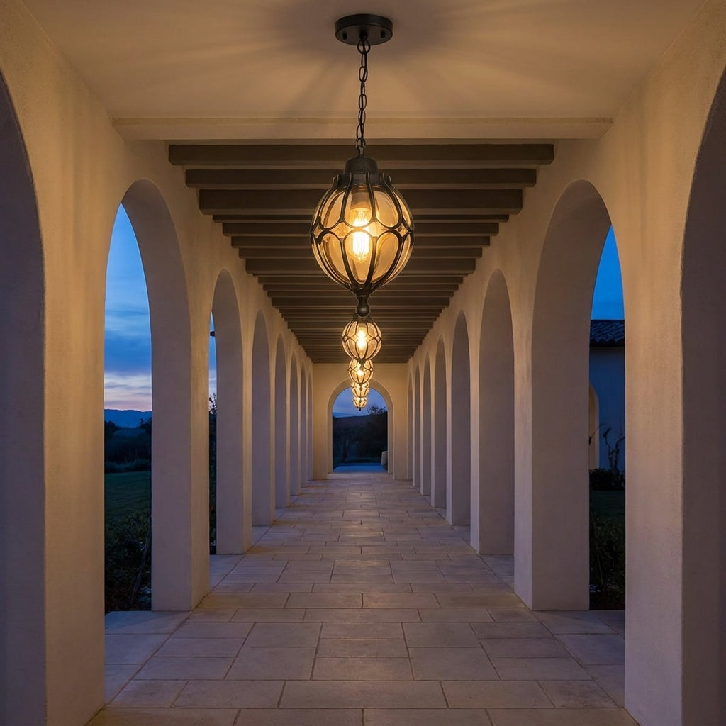 Outdoor Glass Globe Pendant Light – hanging in a covered stone walkway at dusk
