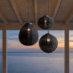 Black Rattan Outdoor Pendant Lantern – trio hanging from beams overlooking the sea