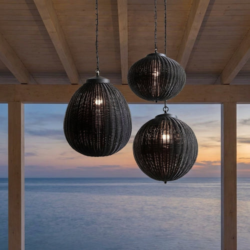 Black Rattan Outdoor Pendant Lantern – trio hanging from beams overlooking the sea