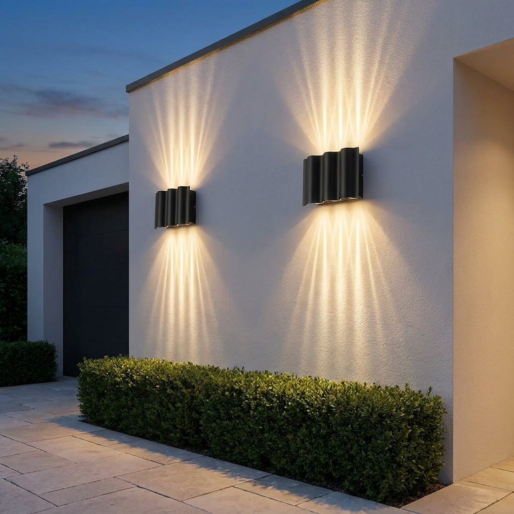Black Up & Down Outdoor Wall Light – pair up and down lit beside a hedge