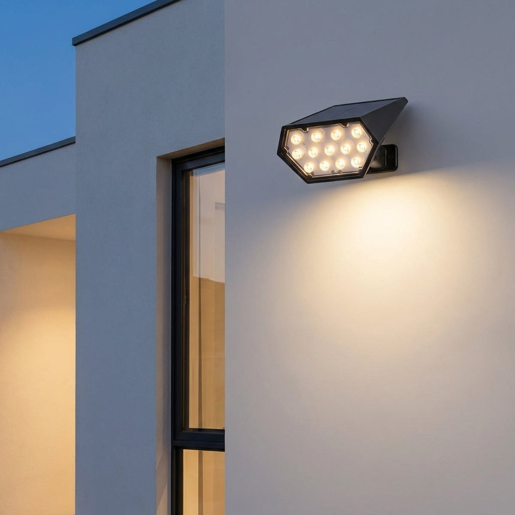 Solar LED Landscape Spotlight – mounted on an exterior wall, lit at dusk