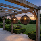 Black Rattan Outdoor Pendant Lantern – pair hanging from a pergola above a lawn