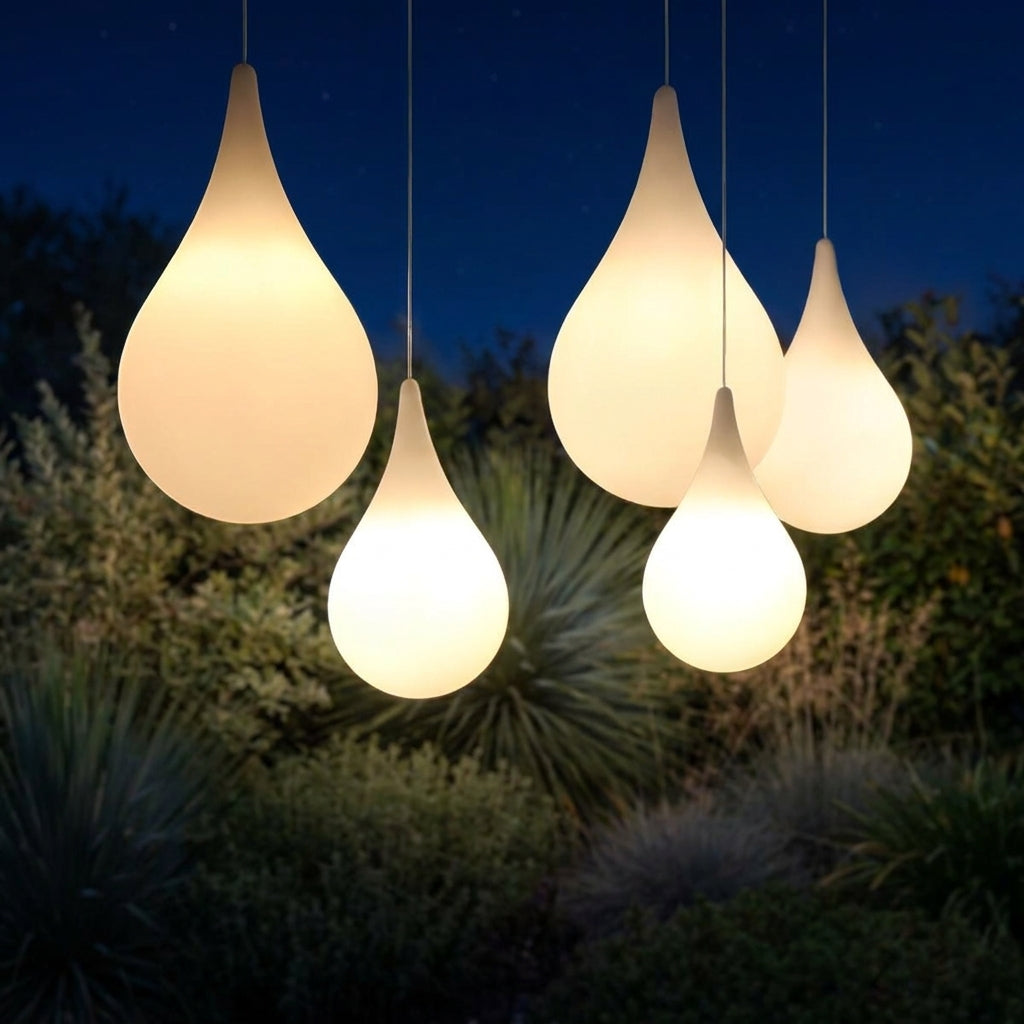 Water Drop Outdoor Pendant Light – five pendants glowing amid garden greenery at night