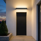 Slim Outdoor LED Wall Washer Light – mounted above a dark front door at night