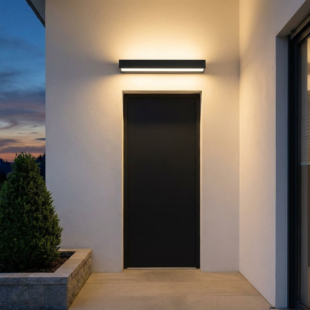 Slim Outdoor LED Wall Washer Light – mounted above a dark front door at night