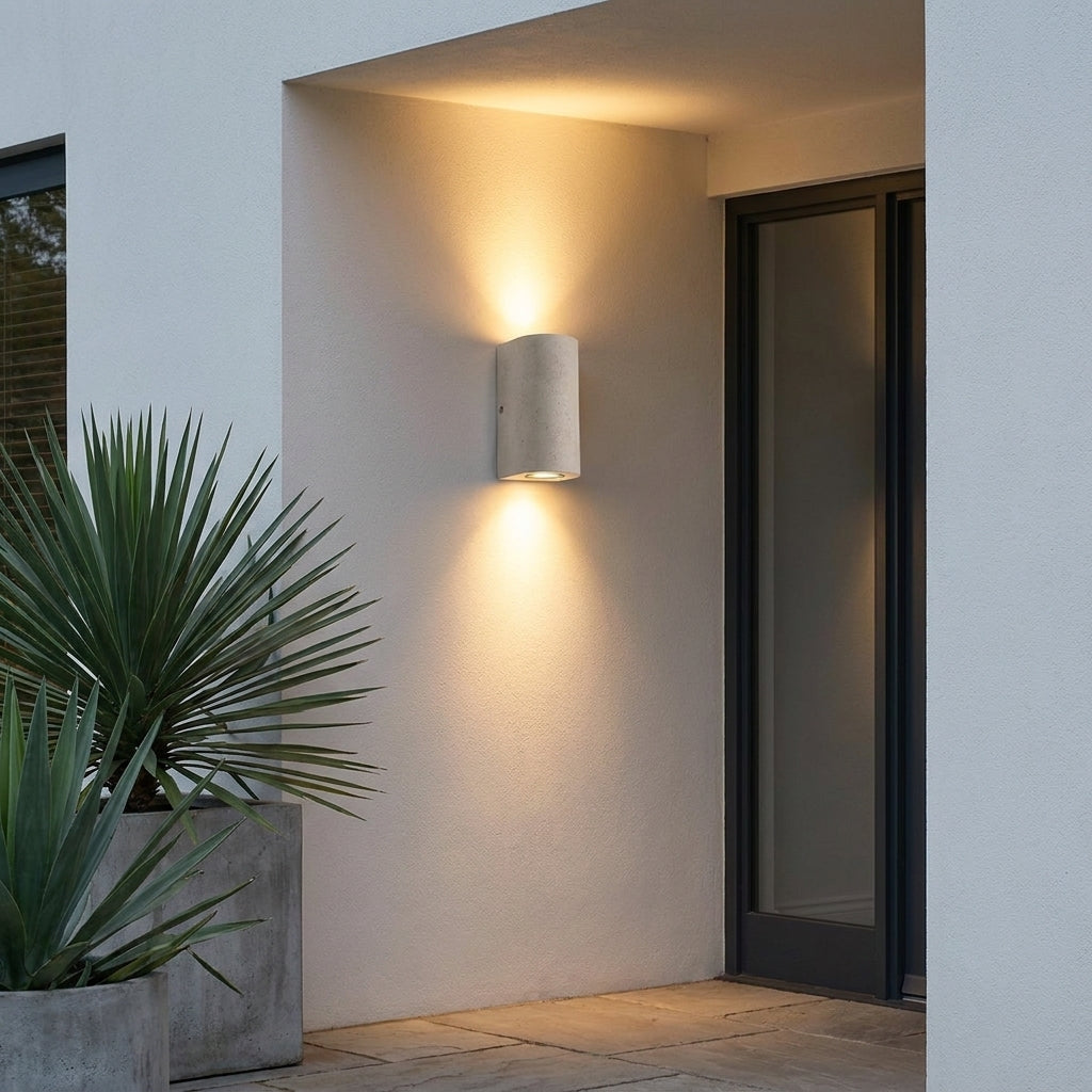 Concrete Outdoor LED Wall Light – mounted beside a glazed door with a plant