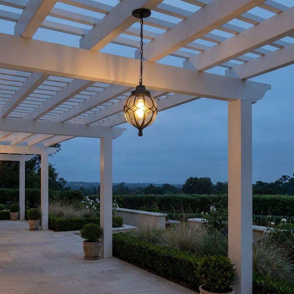 Outdoor Glass Globe Pendant Light – hanging under a white pergola on a patio