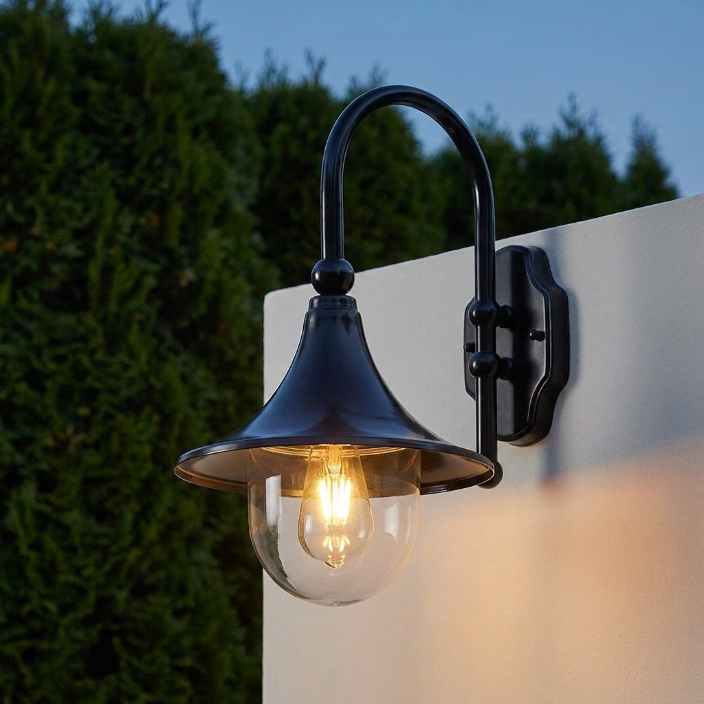 Farmhouse Horn Outdoor Wall Light – on a wall above a hedge at dusk