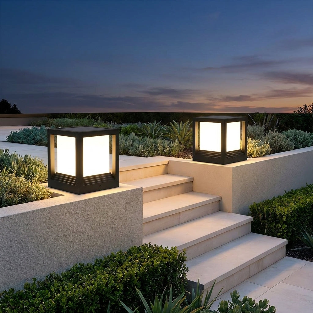 Square Black Solar Fence Post Light – two lanterns lit on garden walls at dusk
