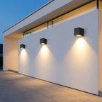Square Outdoor Up & Down Wall Light – three lights mounted along a house wall