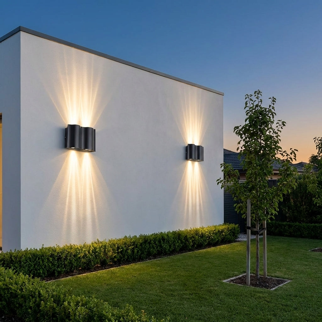 Black Up & Down Outdoor Wall Light – pair up and down lit beside a tree