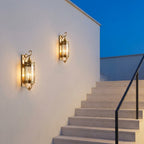 Mid Century Copper Outdoor Wall Lantern – two lanterns lit beside outdoor stairs at dusk