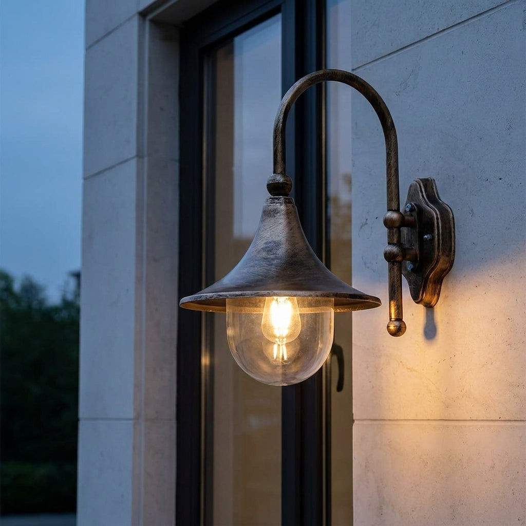 Farmhouse Horn Outdoor Wall Light – lit beside a window at dusk, bronze finish