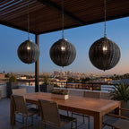 Black Rattan Outdoor Pendant Lantern – trio hanging above a rooftop dining table