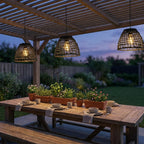 Solar Bell Outdoor Pendant Lantern – lit hanging over an outdoor dining table