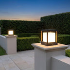 Square Black Solar Fence Post Light – two lanterns lit on stone gate posts
