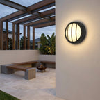 Round Outdoor LED Porch Wall Light – mounted under a pergola beside a fire pit