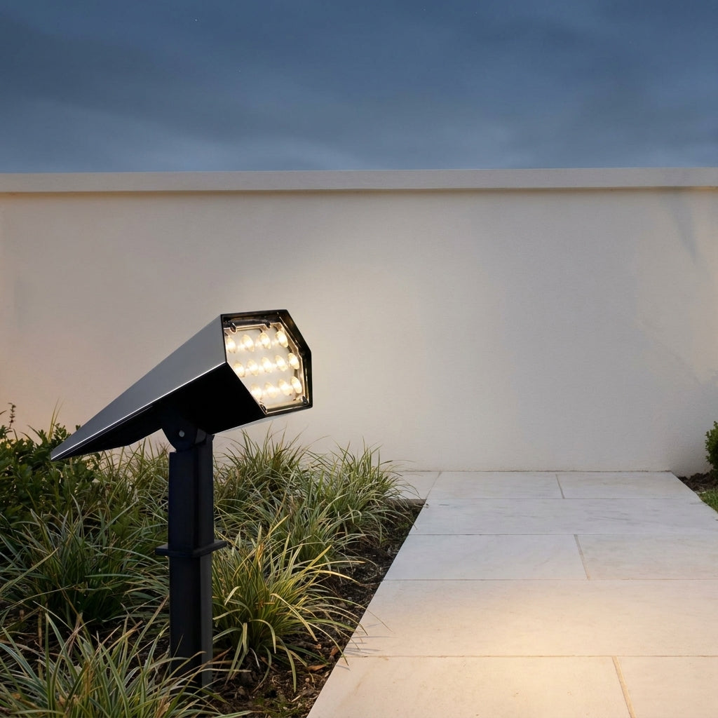 Adjustable Solar Garden Spotlight – lit beside grasses on a path at night