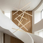 White Linear LED Chandelier – lit fixture against a wood-slatted feature wall
