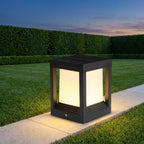 Square Black Solar Fence Post Light – lit on a lawn edge at dusk
