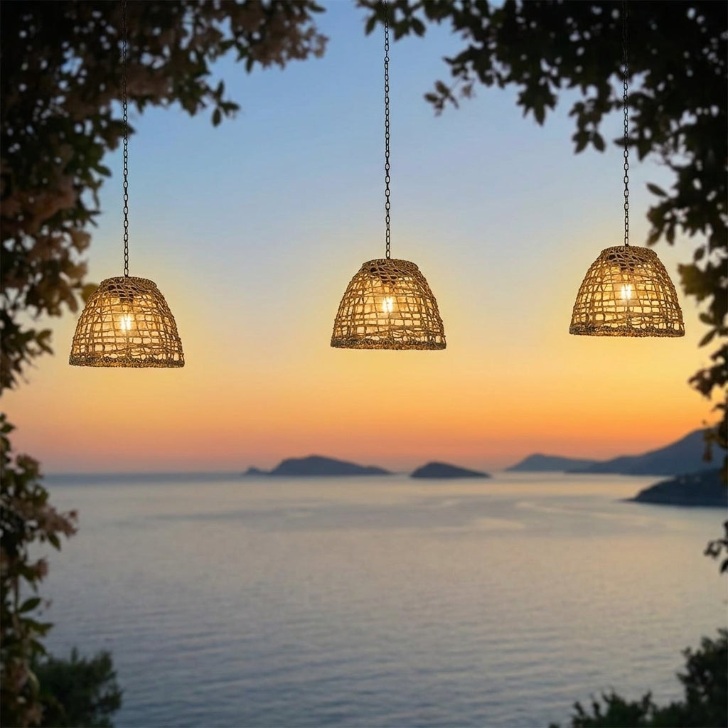Solar Bell Outdoor Pendant Lantern – lit hanging above a sea view through trees