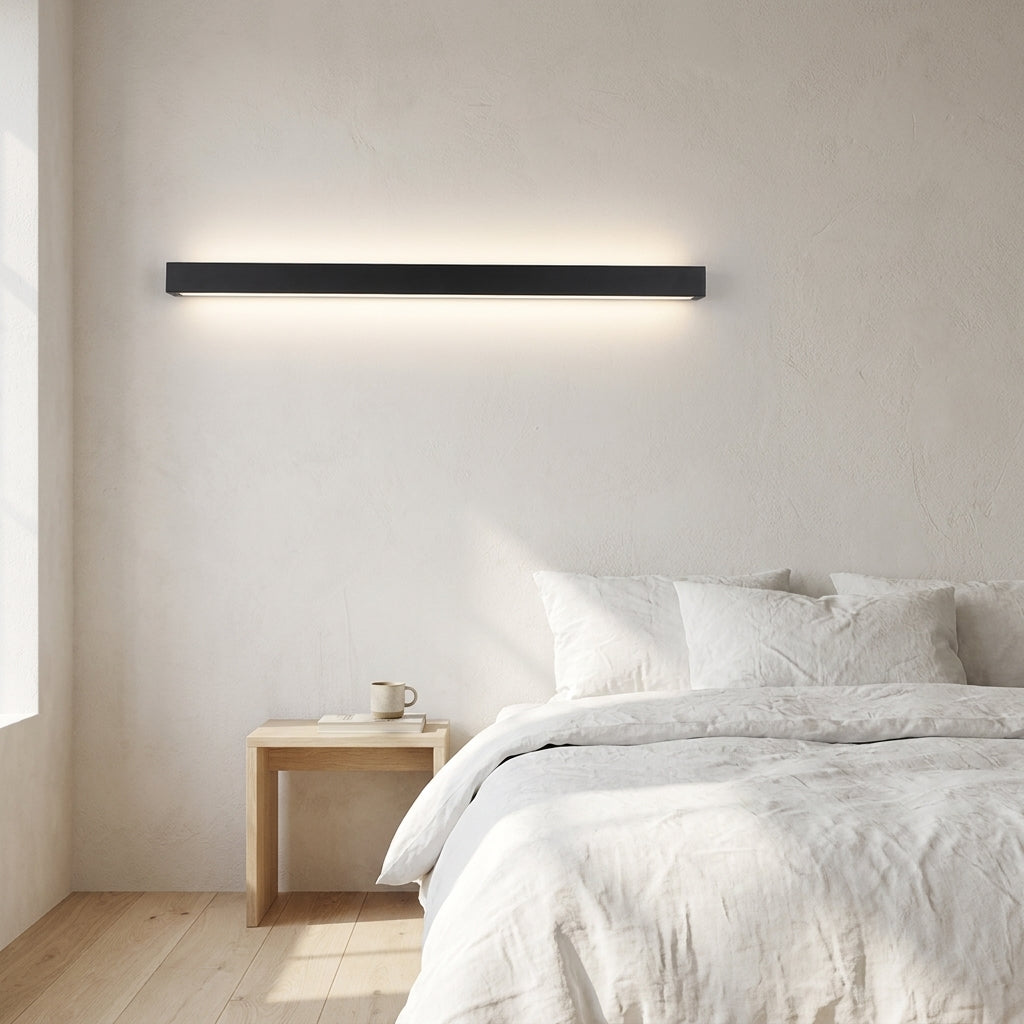 Wooden Up & Down LED Wall Light – lit above a bed beside a nightstand