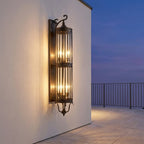 Mid Century Copper Outdoor Wall Lantern – mounted on a wall overlooking the sea at dusk