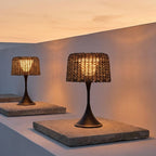 Woven Solar Outdoor Floor Lamp – two table lamps on stone pavers at dusk