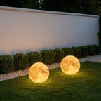 Solar Moon Ball Garden Lights – two moon lights on grass beside a wall