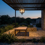 Outdoor Glass Ball Chandelier – hanging over a patio table at dusk