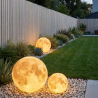 Solar Moon Ball Garden Lights – three moon lights among rocks and grasses
