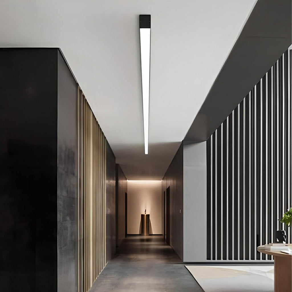 Slim Dimmable LED Linear Ceiling Light – lit above a dark corridor with a sculpture