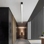 Slim Dimmable LED Linear Ceiling Light – lit above a dark corridor with a sculpture
