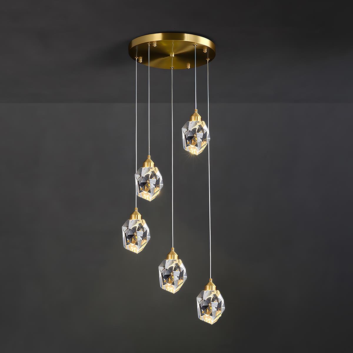 Brass & Crystal Dimmable Pendant Light – five faceted pendants cascading on a dark background