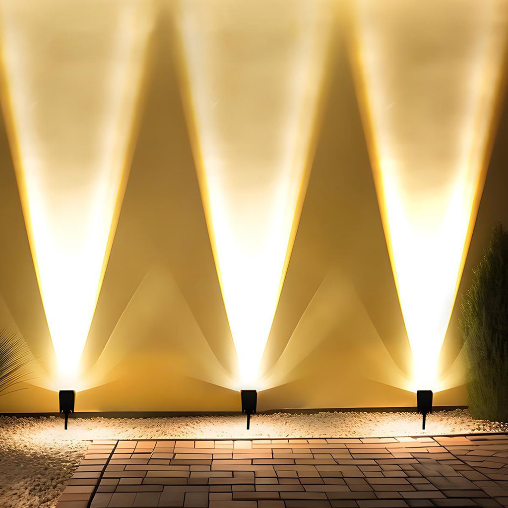 Solar Zoom Garden Spotlight – three spotlights uplighting a wall at night