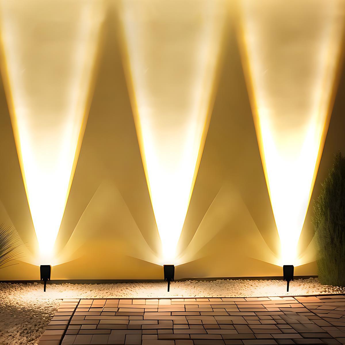 Solar Zoom Garden Spotlight – three spotlights uplighting a wall at night
