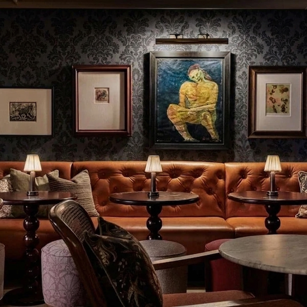 Wren Fabric Table Lamp – lit on tables in a dark panelled bar