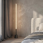 Slimline 360 LED Floor Lamp – lit beside a bed, black finish