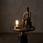 Ebba Table Lamp – on a marble table beside a bronze sculpture