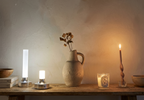Ebba Table Lamp – two colour finishes on a wooden shelf