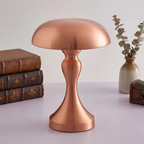 Rune Table Lamp – copper finish beside stacked books